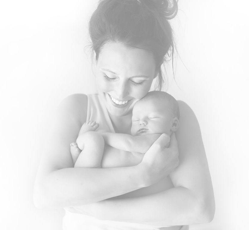 Black and white photograph of a mum smiling down at her newborn baby during a Noosa lifestyle portrait session