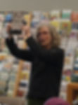 Photo of Jennifer holding up one of the plates during the launch. © Curtis Manley, 2024.