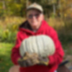 Author photo of Sue Heavenrich holding a large pumpkin.