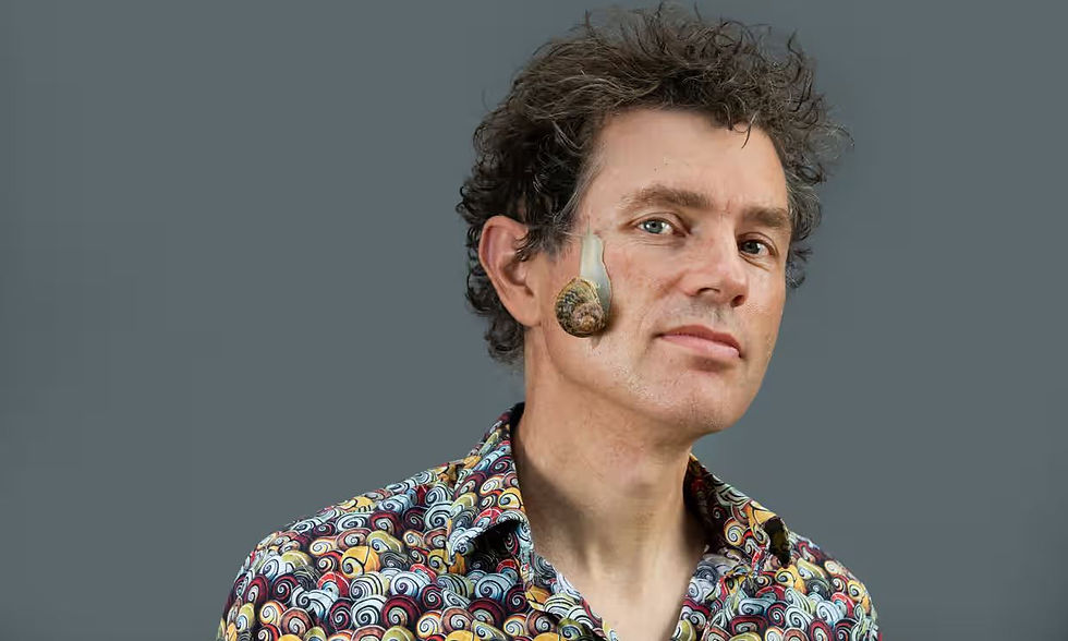 Photo of Dr. Davison with a snail on his face.
