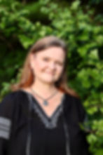 Photo of author Michelle Cusolito, standing in front of a Ginko tree.
