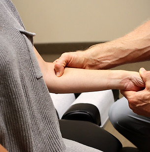 Close-up of hands applying soft tissue therapy for injury recovery