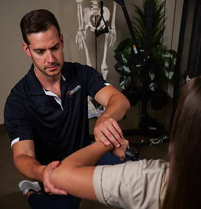 Patient receiving movement-based rehabilitation therapy with Dr. Gallo at Next Level Chiropractic