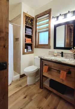 High-end modern bathroom showcasing an immaculate custom tile walk-in shower and beautiful custom ca