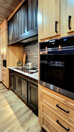 Close-up detail of premium gourmet kitchen finishes highlighting sleek granite countertops and a pro