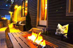 A cozy backyard space featuring premium conversation seating arranged perfectly for six guests, an i