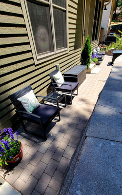 A cozy backyard space featuring premium conversation seating arranged perfectly for six guests, with