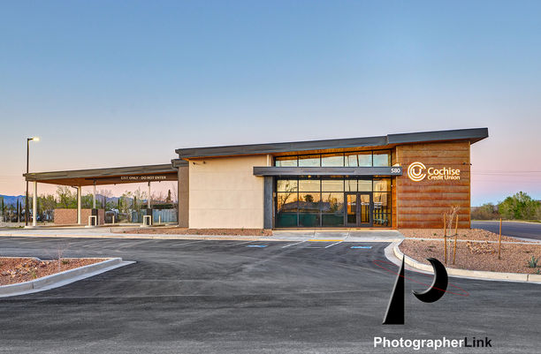 Contemporary Cochise Credit Union branch with large windows, illuminated signage, drive-thru, ample parking, and desert landscaping
