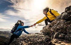 helping hiker up rockface.jpg