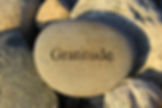 Image of a rock carved with the word "Gratitude"