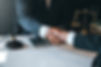 Businessman shaking hands to seal a deal with his partner lawyers or attorneys discussing