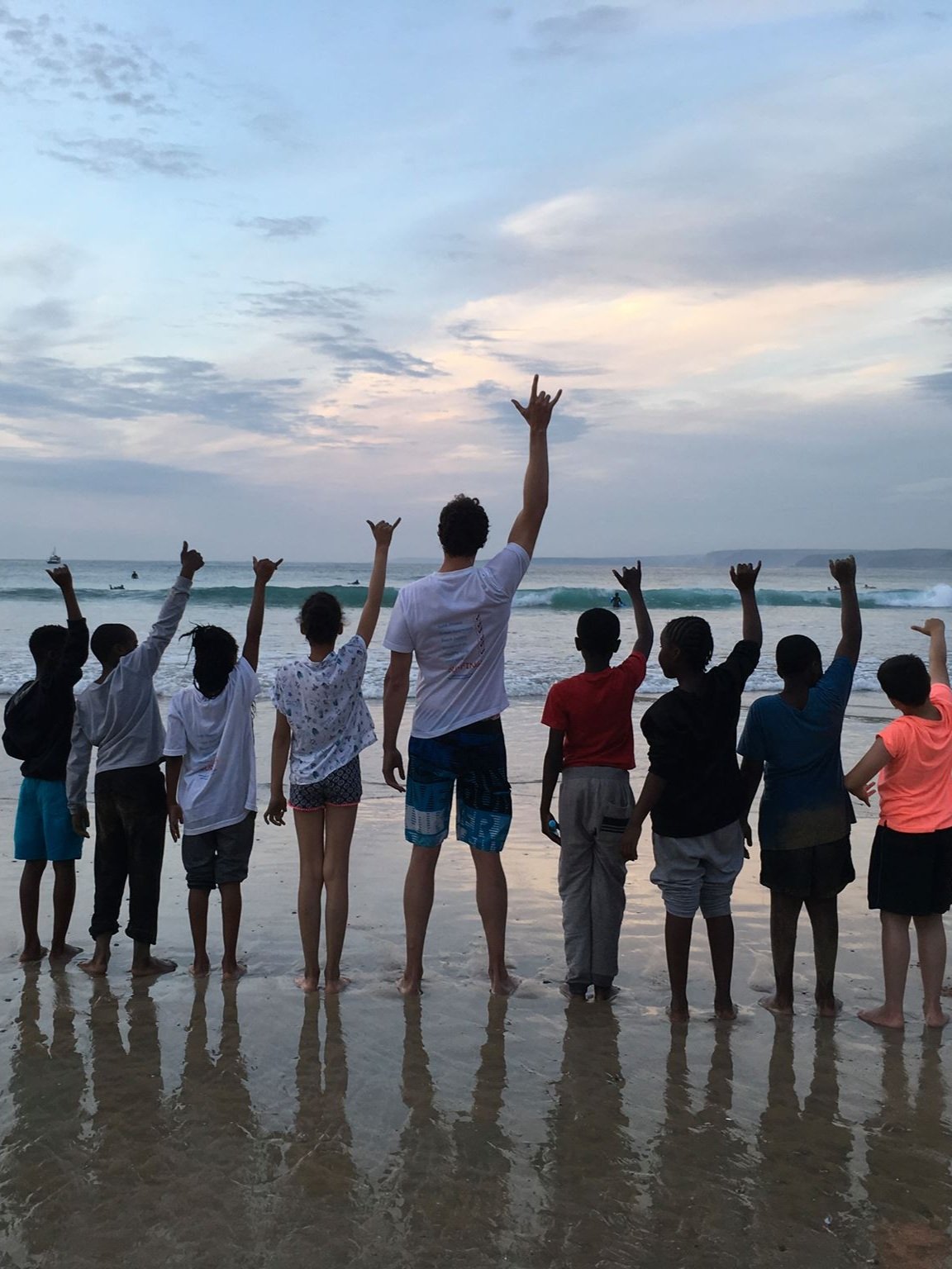 Children from City Kids Surfing on the beach looking out at the sea