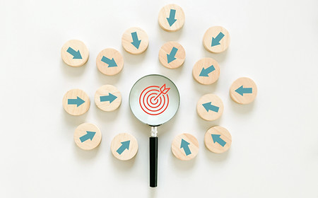 Targeting the business concept. Magnifying glass with a red target icon in the center and