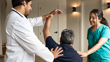 A CNA helping a doctor with a ptient