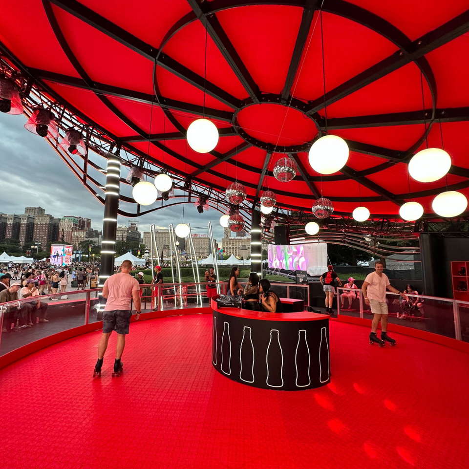 Coke Studio skating rink pavilion at Lollapalooza featuring a central DJ booth by Raven PMG.