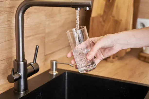 woman-pour-clean-water-from-tap-filter-into-a-glass.jpeg