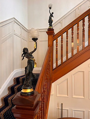 Liberty statues on Victorian staircase