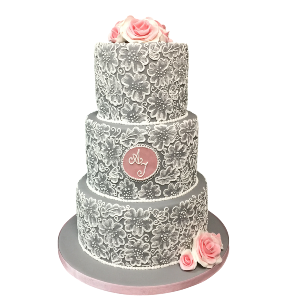 Three-tiered grey wedding cake with white lace and pink sugar roses.