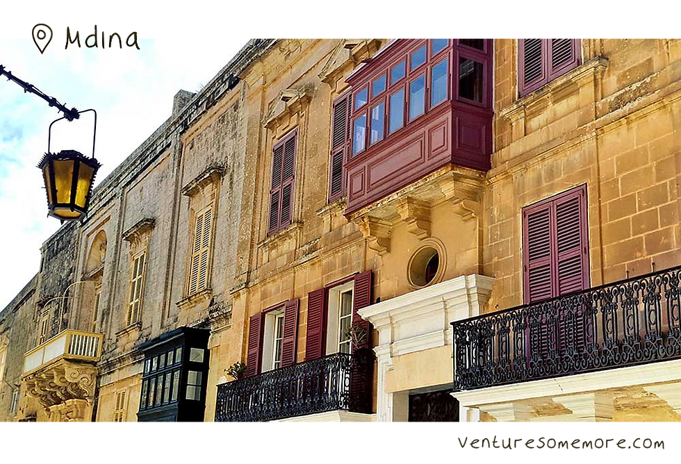 A street in the medival wall city of Mdina in Malta with baroque style windows and lanterns