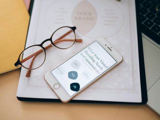 glasses and a phone on a notebook
