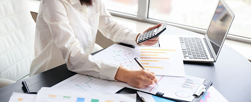 Accountant writing on a document to develop personalised financial strategies for sole traders