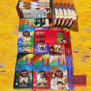 Assorted boxed beverages arranged on a yellow carpet.