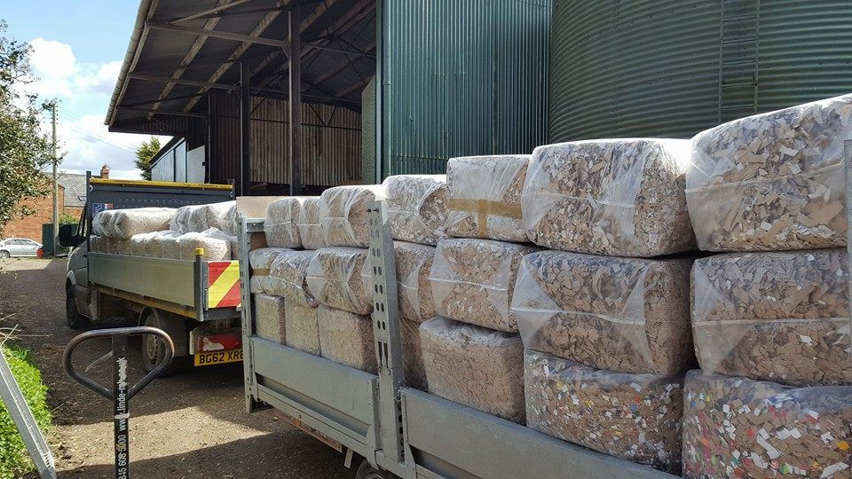 stacks of bags loaded on a trailer outside a warehouse