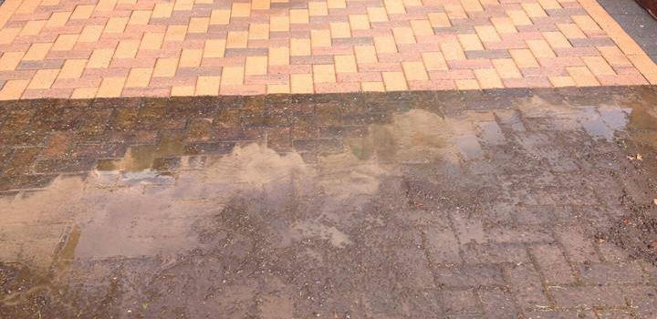 A wet, muddy brick pathway transitions into a clean, dry beige and red brick patio