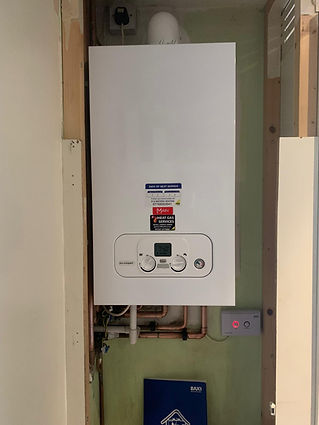 Detail view of a white domestic boiler highlighting the control panel and digital display