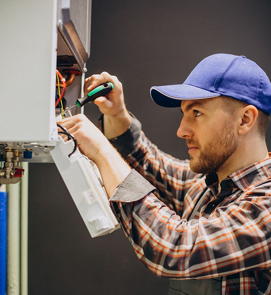 a technician inspecting and repairing boiler