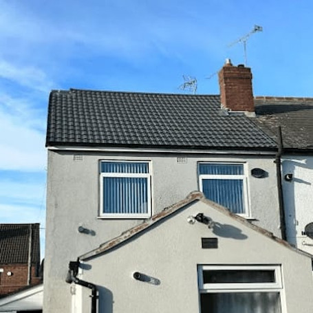 A house with a newly tiled dark grey roof