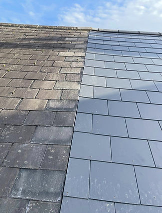 Comparison of old, weathered slate tiles next to new, smooth grey slate tiles on a roof
