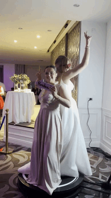Party guests using a 360 photo booth with LED lighting and rotating camera for cinematic videos.