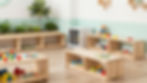 Bright room with wooden shelves, toys, and plants at Luz Family Daycare
