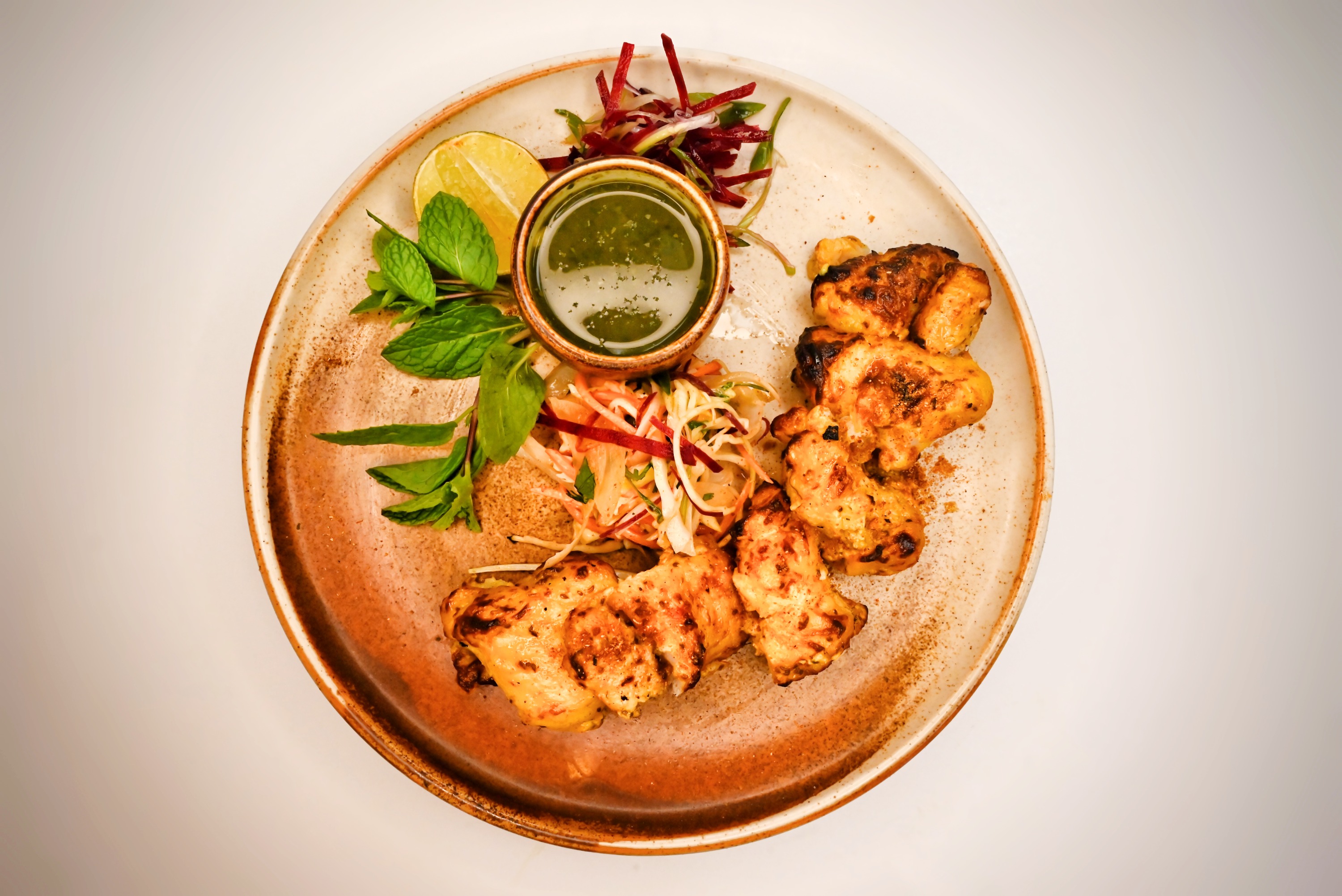 Grilled fish tikka with mint chutney and lemon