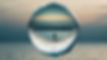 human being captured in a drop of water over an ocean.jpg