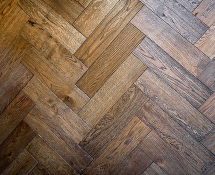 Close-up of wood flooring laid in a herringbone pattern