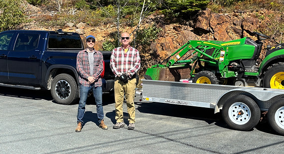 Bob and Jeremie, the company founders with truck and excavator ready for water storage tank installation and site excavation.