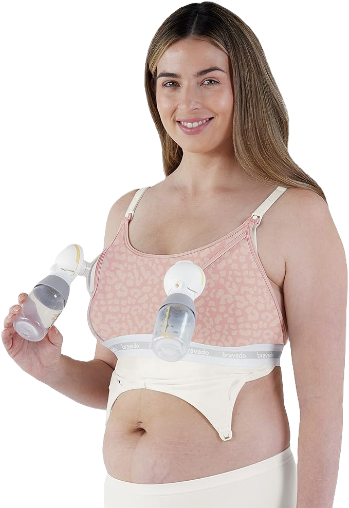 a woman in the bravado pumping bra smiling and holding a part of her breastpump