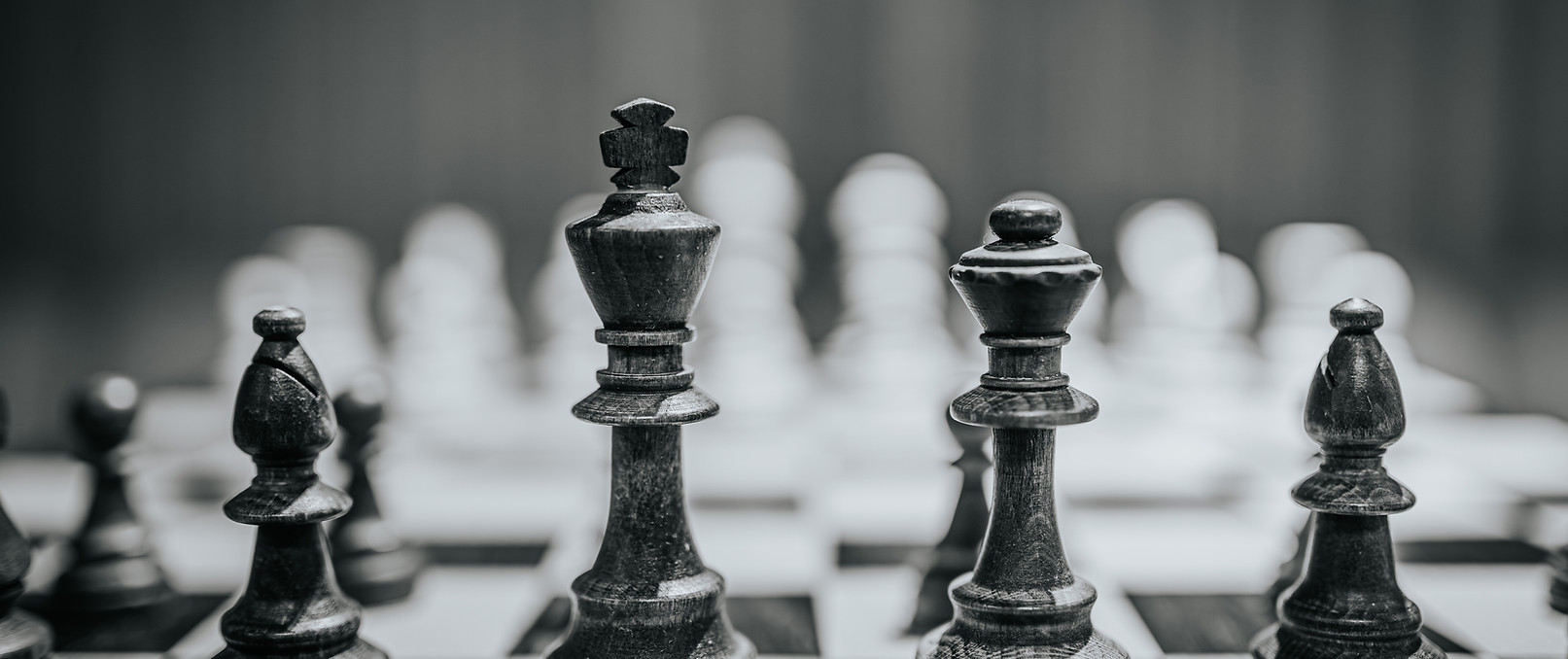 Chess pieces are prominently displayed on a chessboard, with the king and queen highlighte