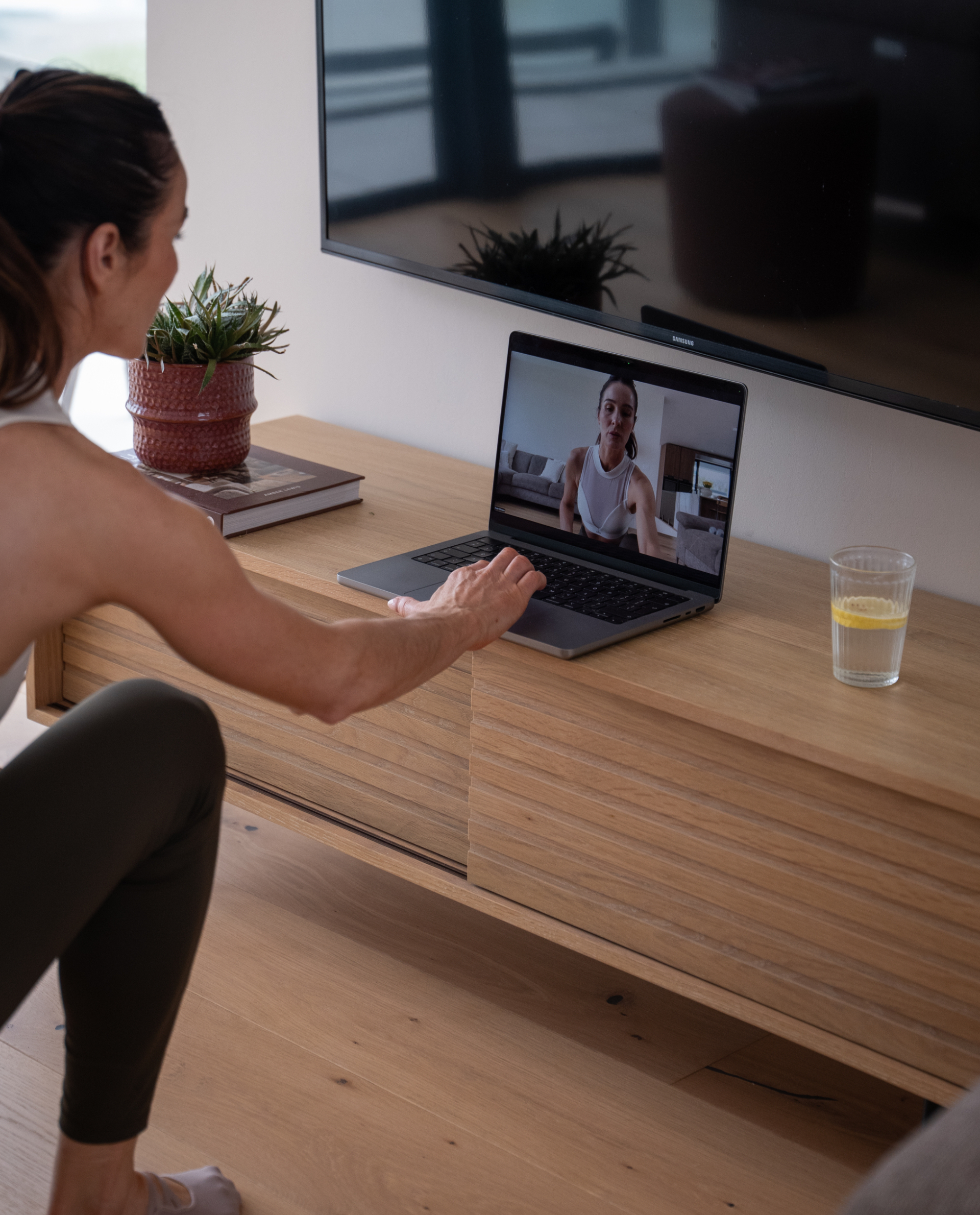 A serene woman practices yoga in soft morning light representing the live better launch.