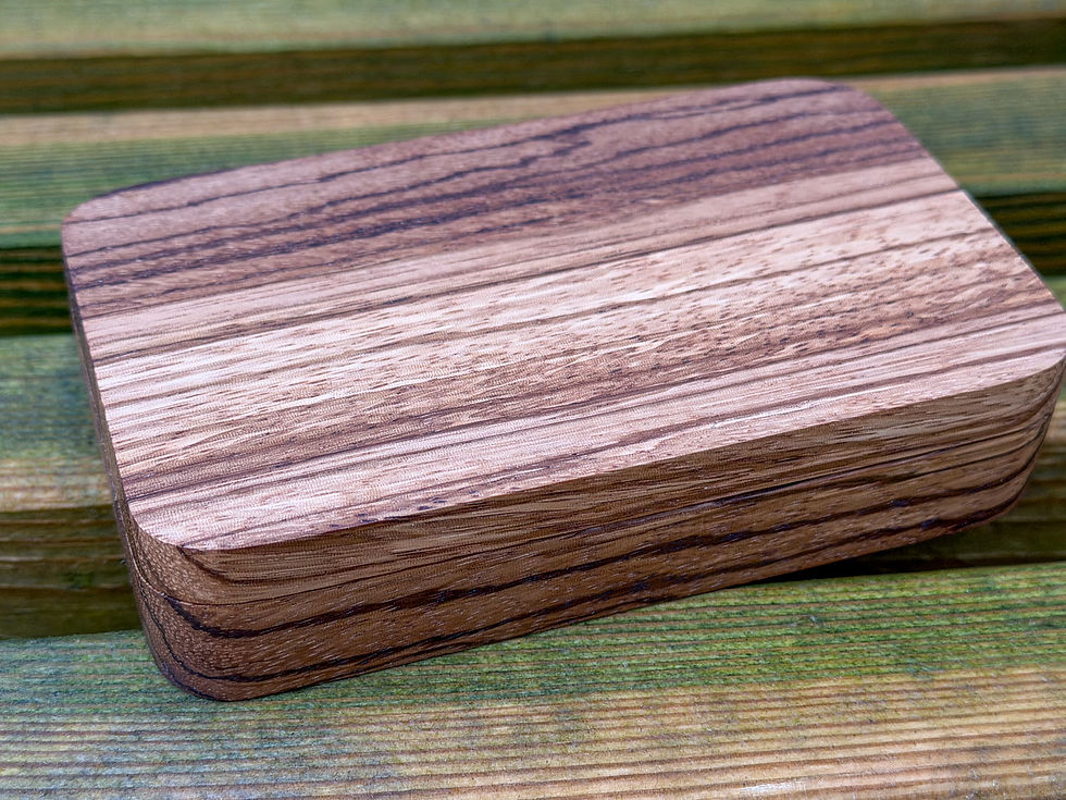 Thumbnail: beautiful oak walnut zebrano hardwood handmade fly fishing box case with a wooden back ground on a wooden bench uk made