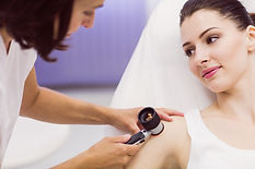 dermatologist-examining-skin-patient-with-dermatoscope.jpg