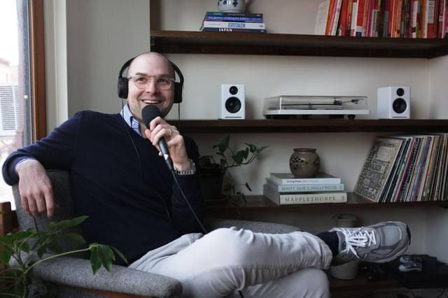 A gentleman influencer podcast host recording with a mic.