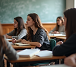 A-group-of-theology-students-are-sitting-in-a-classroom-with-textbooks-and-papers-on-their