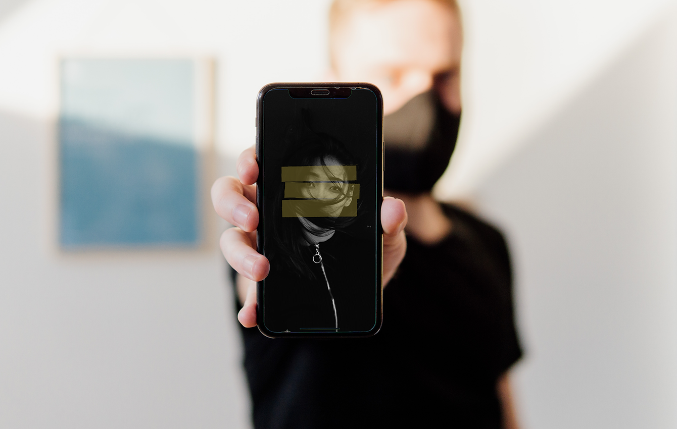 man holding graphic logo on iPhone screen