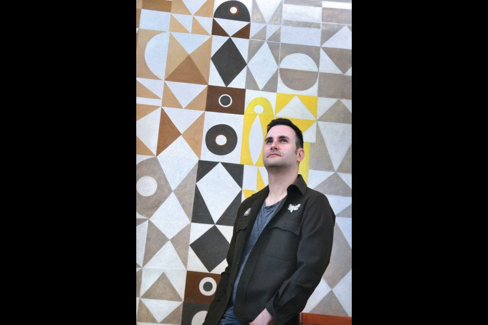 Eye-level view of a restored B.C. Binning mural inside the Binning House, showcasing intricate geometric patterns and subtle earth tones