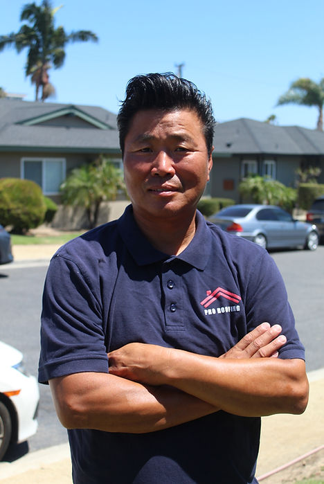 GCC Development Co. owner standing confidently outdoors in his company shirt representing leadership.