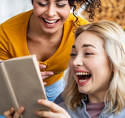 portrait-women-laughing-while-reading-book.jpg