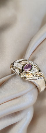 Handmade sterling silver signet ring with gold leafs and pink sapphire as a centerpiece.